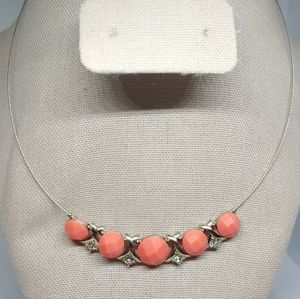 Coral colored beaded wire necklace